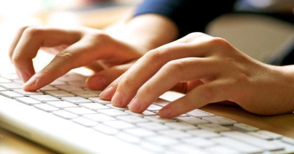 blog picture of pair of hands on a computer keyboard