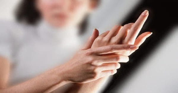 blog picture of lady grabbing her hand in pain