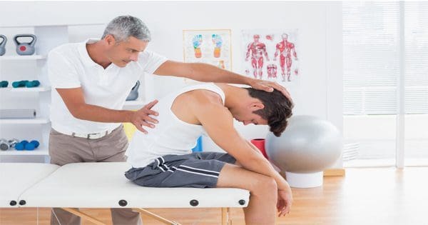 Chiropractor stretching mans back