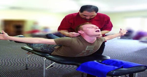 blog picture of man receiving network therapy from chiropractor