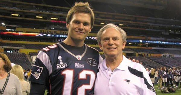 blog picture of football quarterback and chiropractor on field smiling for camera