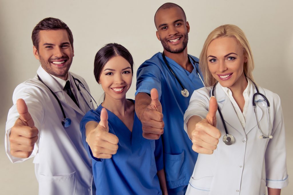 blog picture of doctors smiling with their thumbs up