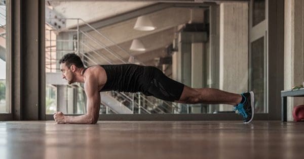blog picture of man doing core push ups in his apartment