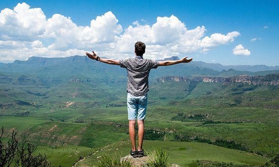 blog picture of a man standing on a hill over looking the country side