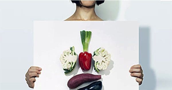 blog picture of lady holding a board with vegetables