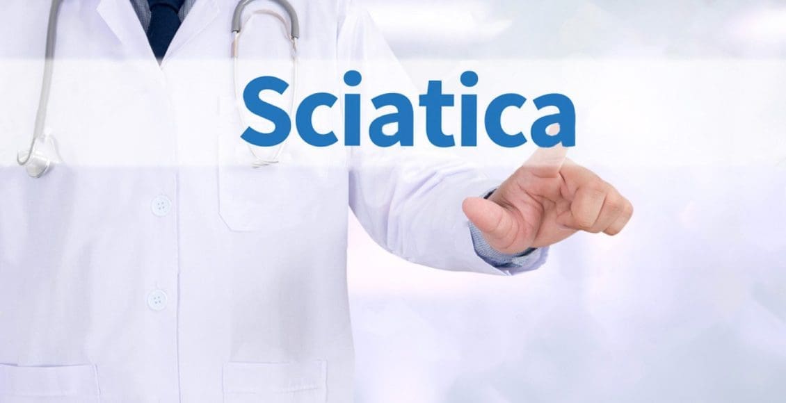 blog picture of doctor working touch computer pressing the word sciatica