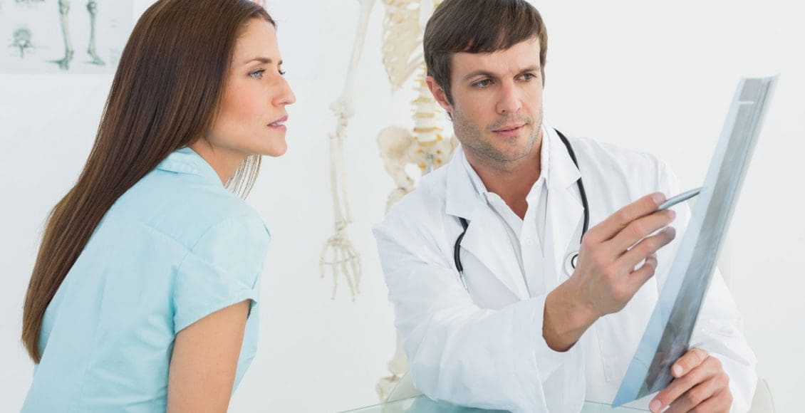 male doctor explaining ray to female patient