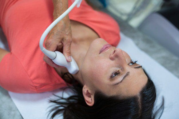 woman getting ultrasound of thyroid