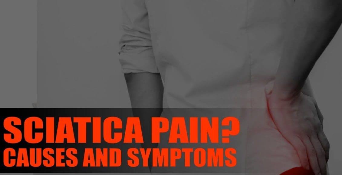 Image of a person holding their back due to sciatica.